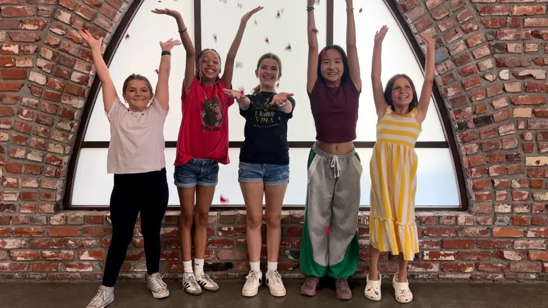 Campers throwing petals for a shot on the brick-arch stage