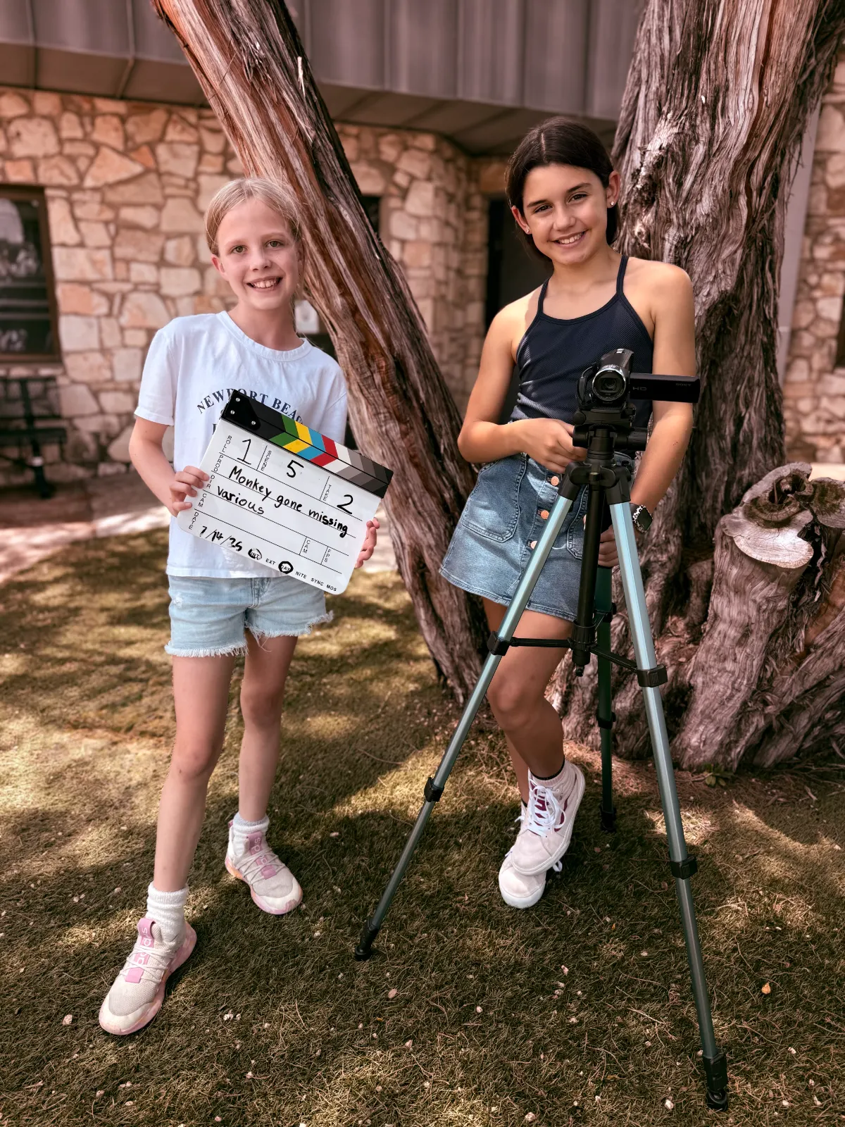 One-day filmmaking intensive — two kids running the slate and camera together on a Film Camp set