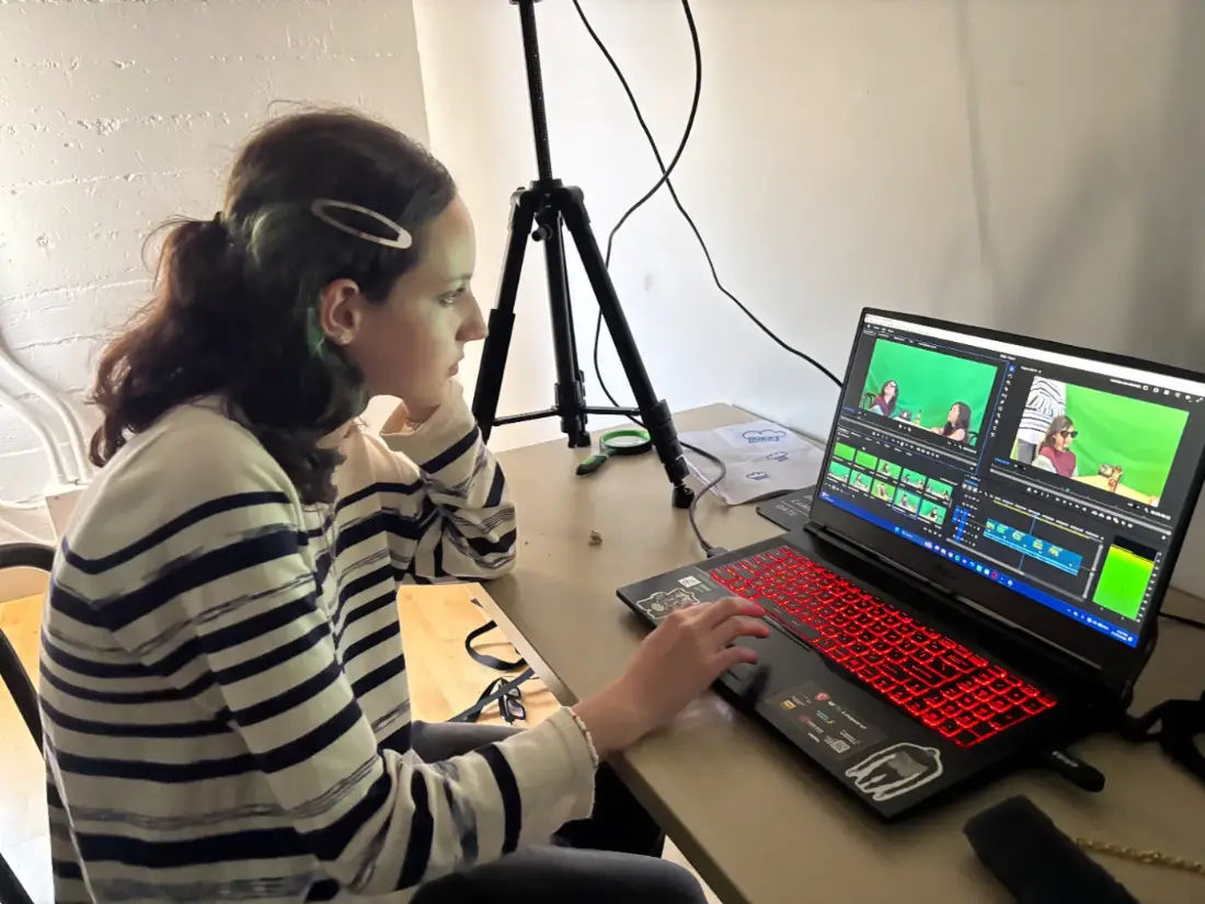 Video editing camp for teens — a teenage editor cutting her own green-screen footage